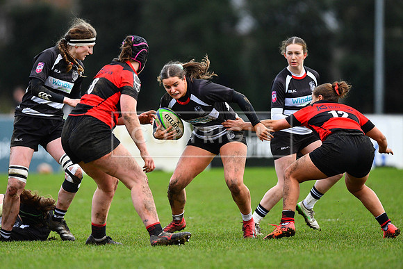 Katie Corrigan of Old Belvedere is tackled by Saher Hamdan of Ennis