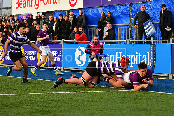 Clongowes left winger Oscar OÕBrien is bundled into touch as he dives for the line.