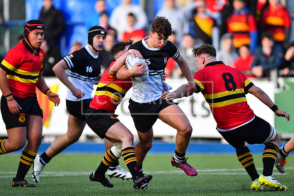 Newbridge College fullback Todd Lawlor in the thick of the action.