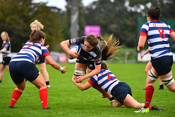 Caoimhe Guinan of Old Belvedere is tackled by Rock's Niamh Griffin.