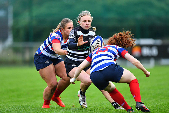 Emma Tilly of Old Belvedere is tackled by Blackrock College's Ella Durkan.