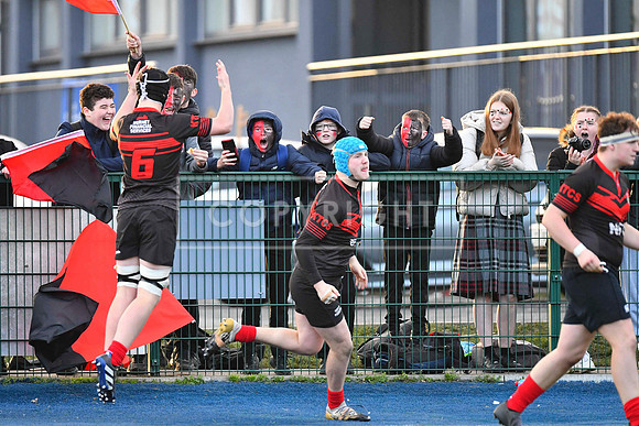 Kildare Town CS flanker Alex Downey celebrates a Kildare try with their supporters.