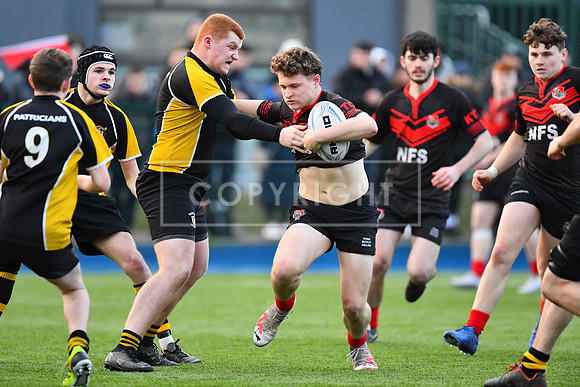 Kildare Town CS outhalf Daniel Halpin is tackled by Eoin Carroll of Patricians.