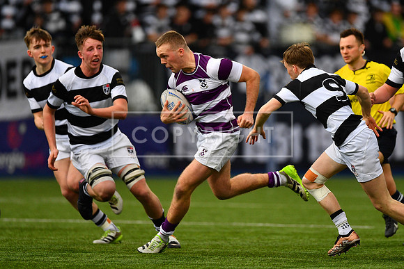 Clongowes Wood outhalf Callum McDonald bursts through the Belvedere College defence to set up his side’s third try.
