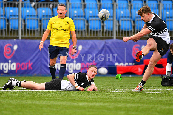 Daniel Connolly looks on as Paddy Taylor kicks for goal.